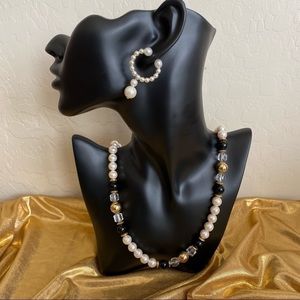 White , black, gold and clear beaded necklace with matching earrings.
